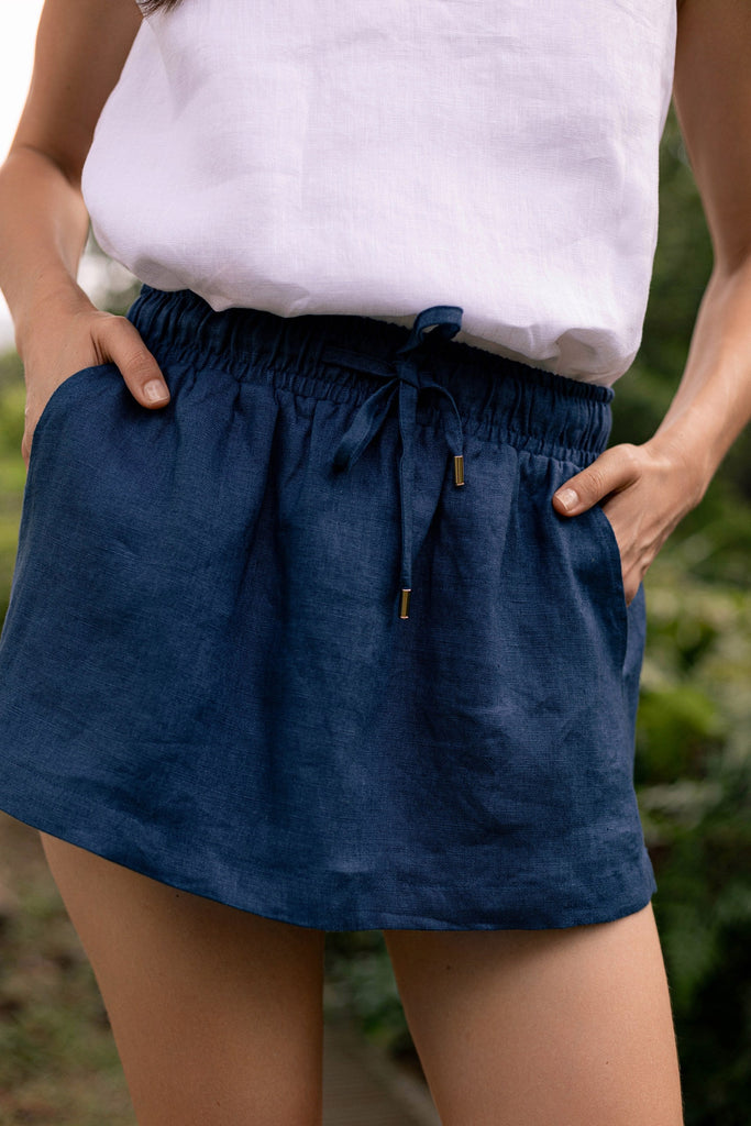 Summery the label's model wearing the classic linen skirt in navy blue