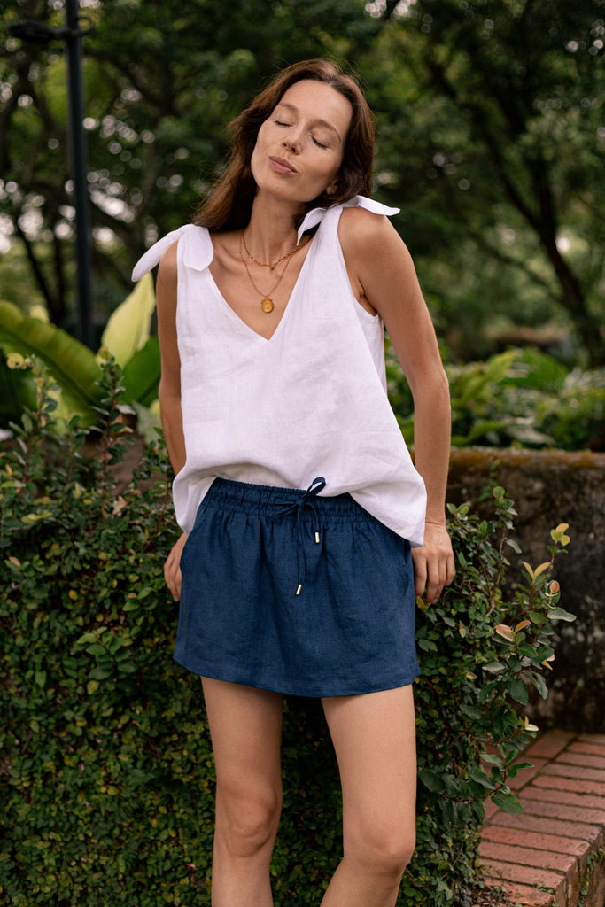 Summery the label's model wearing the classic linen skirt in navy blue
