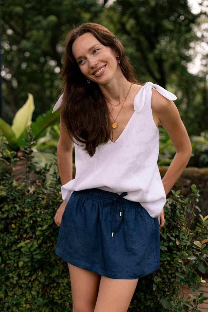Summery the label's model wearing the classic linen skirt in navy blue