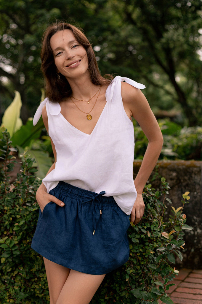 Summery the label's model wearing the classic linen skirt in navy blue