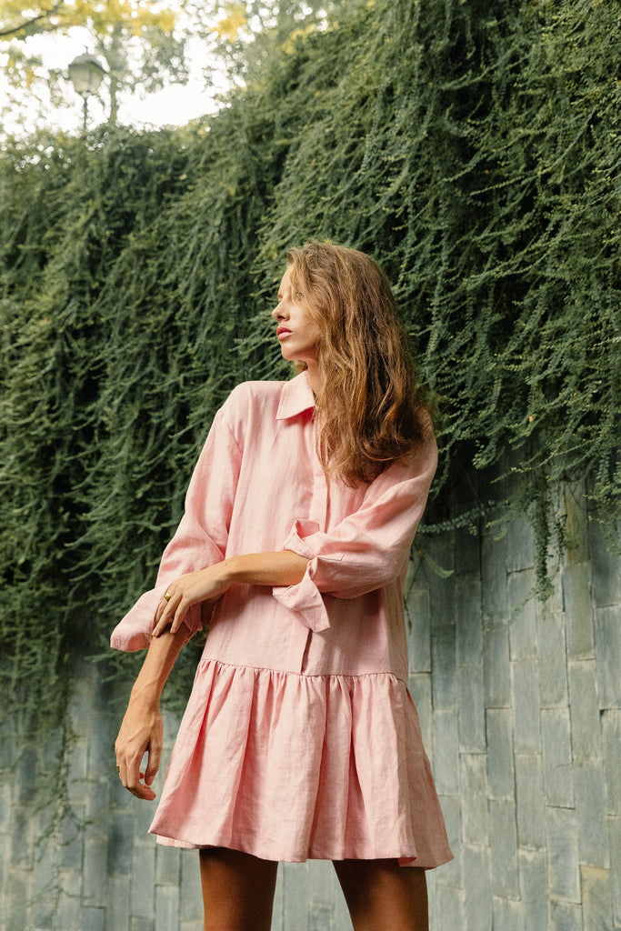 Woman wearing Summery The Label UK classic linen drop waist dress in dusty pink. 