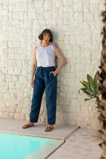 Summery The Label’s navy blue lounge pants made from lightweight linen, styled for relaxed tropical comfort