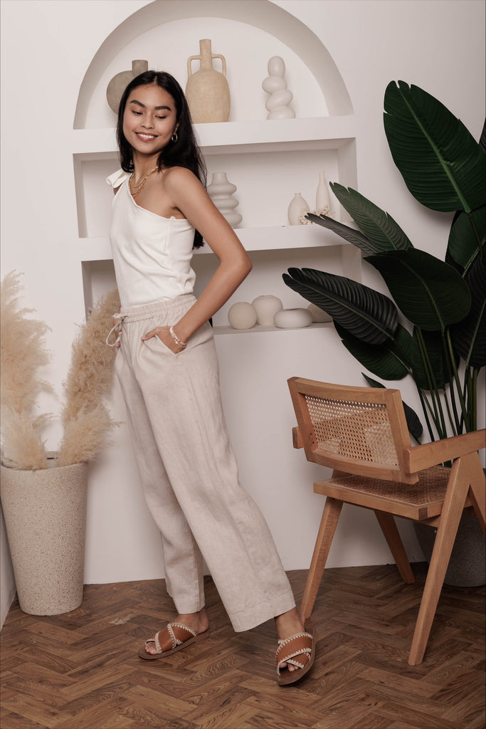 Woman wearing the classic linen lounge trousers in oat