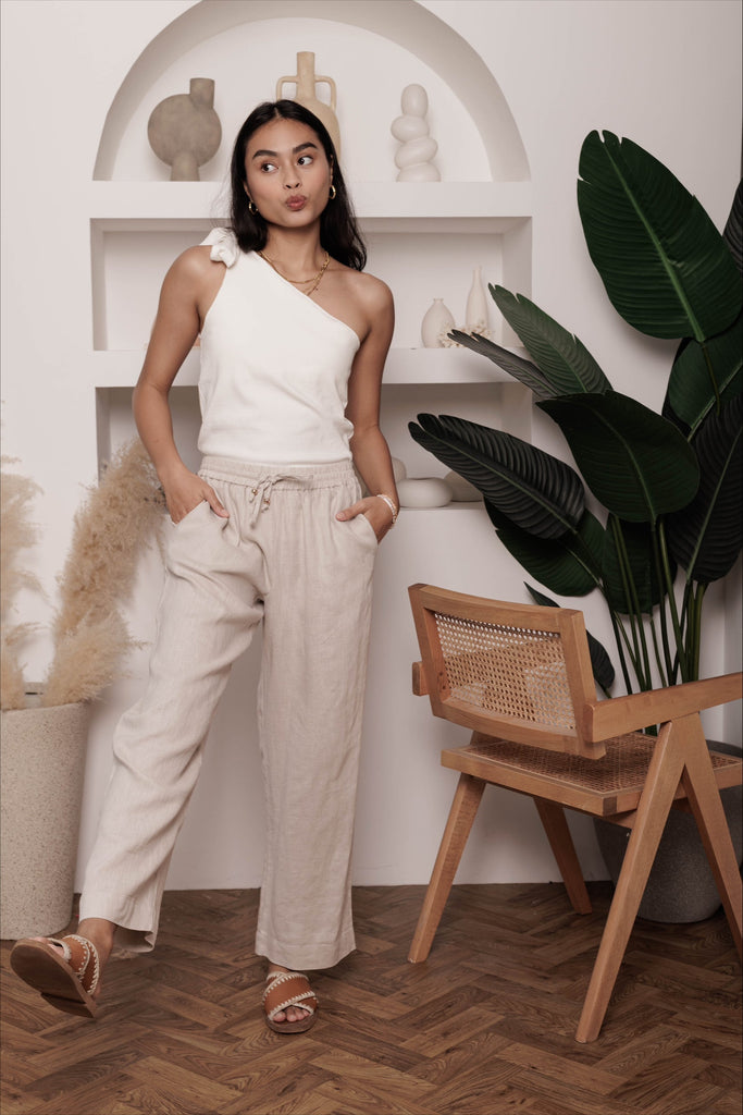Woman wearing the classic linen lounge trousers in oat