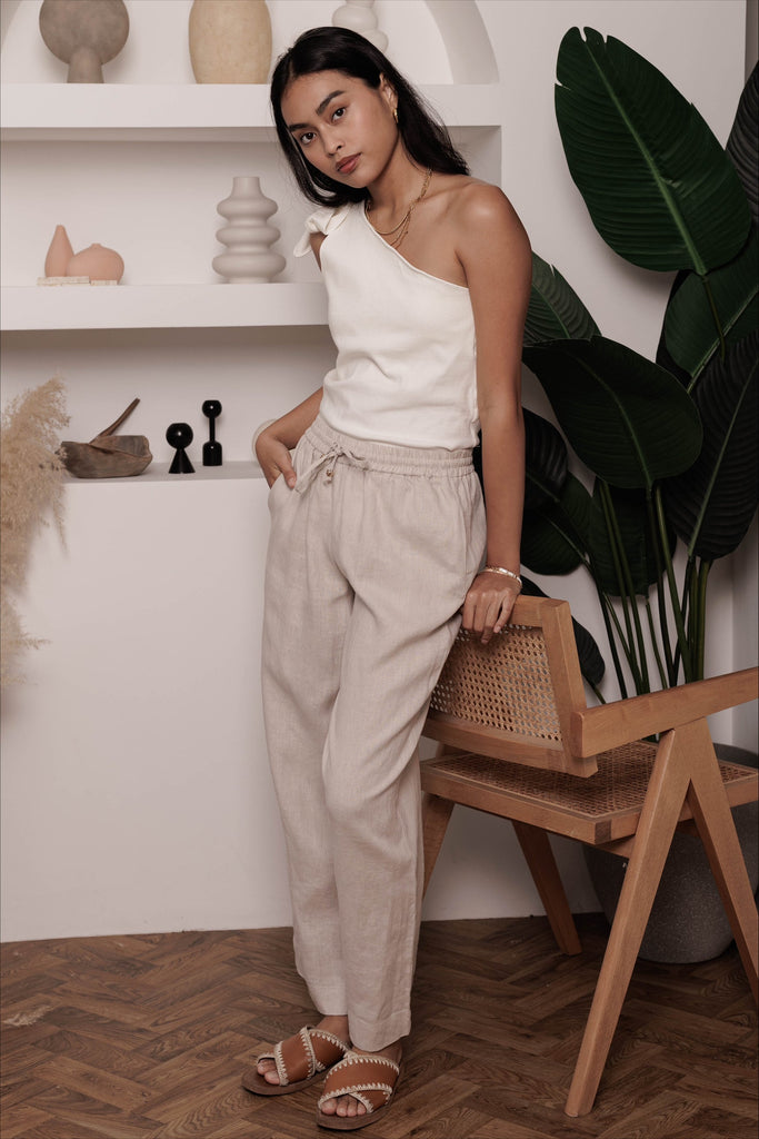 Woman wearing the classic linen lounge trousers in oat