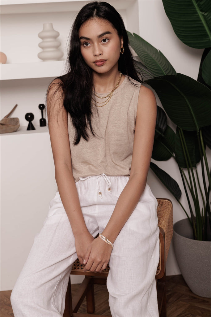 Woman wearing the classic linen lounge trousers in white