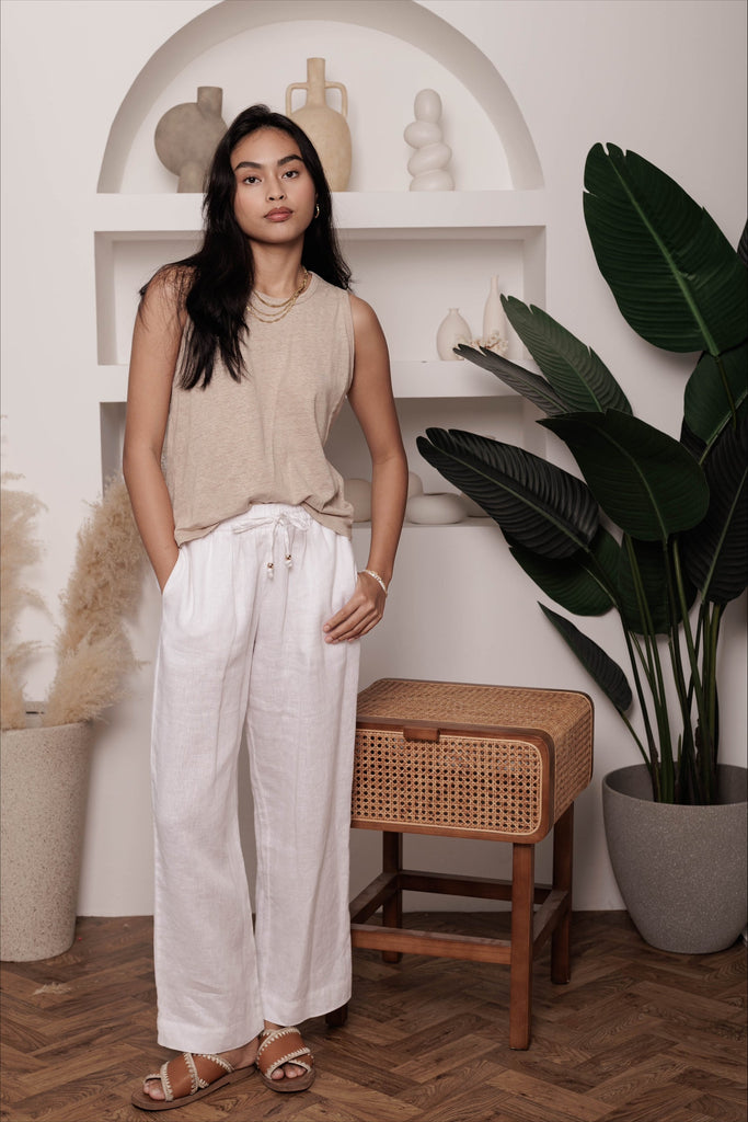 Woman wearing the classic linen lounge trousers in white