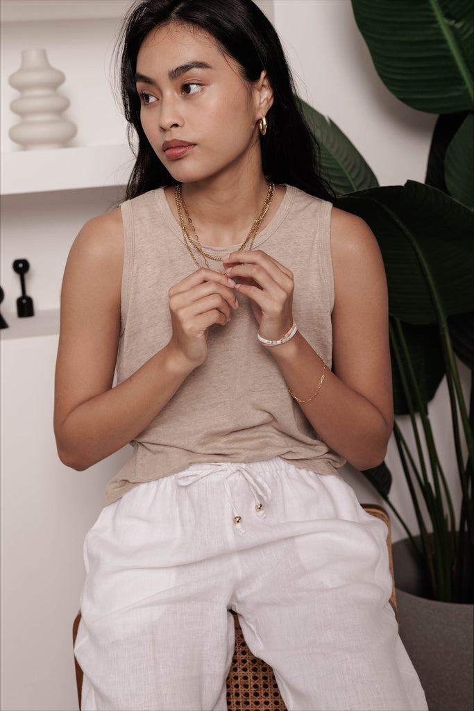 Woman wearing the classic linen lounge trousers in white