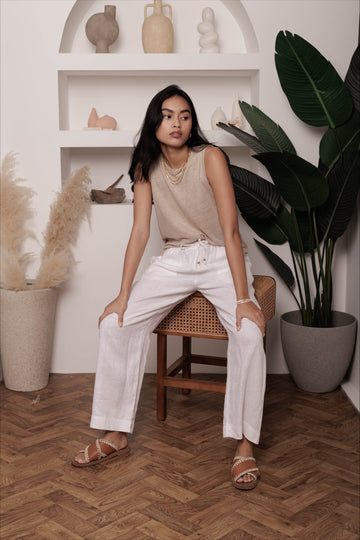 Woman wearing the classic linen lounge trousers in white