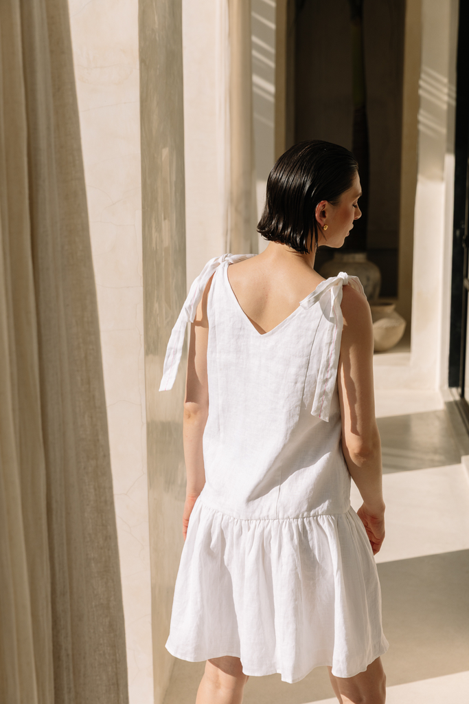 White shoulder-tie dress made from breathable fabric by Summery The Label, ideal for sunny weekends and resort escapes