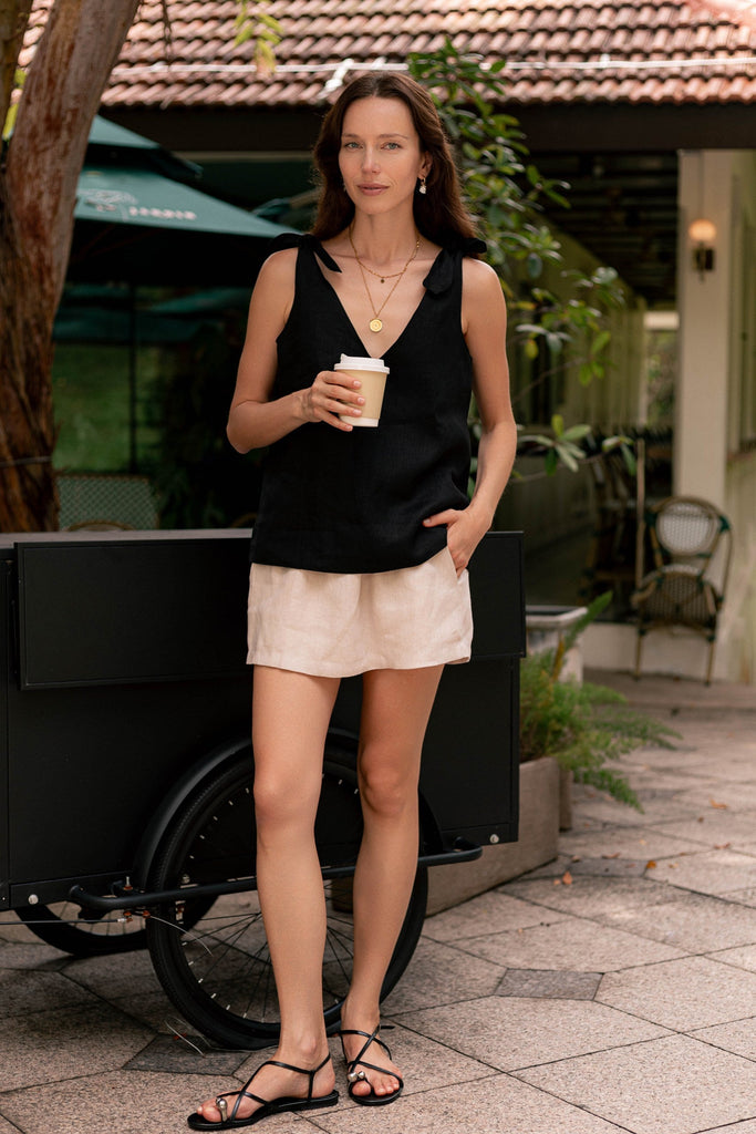 Model wearing the classic linen shoulder bow tie top in black