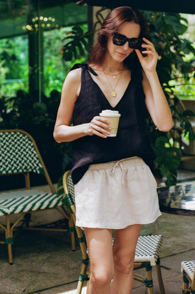 Model wearing the classic linen shoulder bow tie top in black