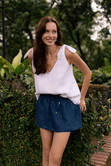 Woman in classic linen shoulder bow tie top in white