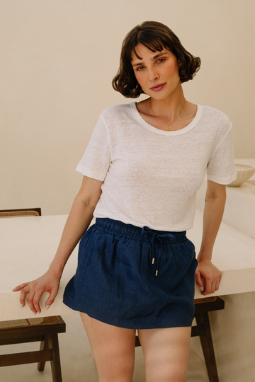 Model wearing a navy blue linen skort from Summery The Label, blending comfort and elegance for European Summers