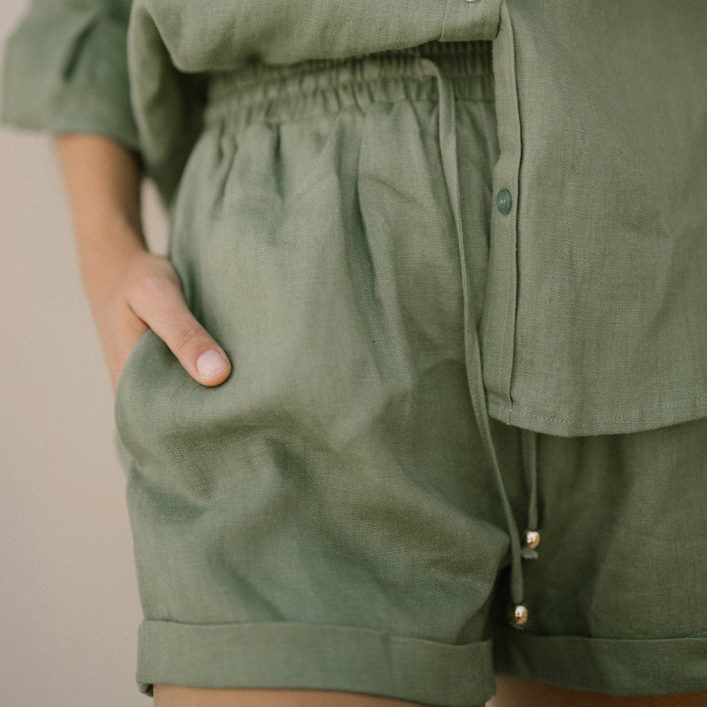Model wearing the classic linen shorts in khaki green