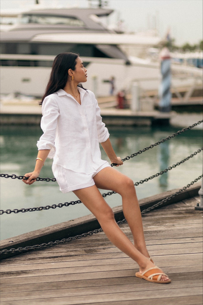 Woman wearing the classic linen shorts in white
